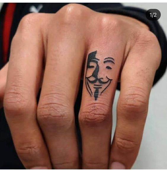 Guy Fawkes Mask Tattoo on Finger